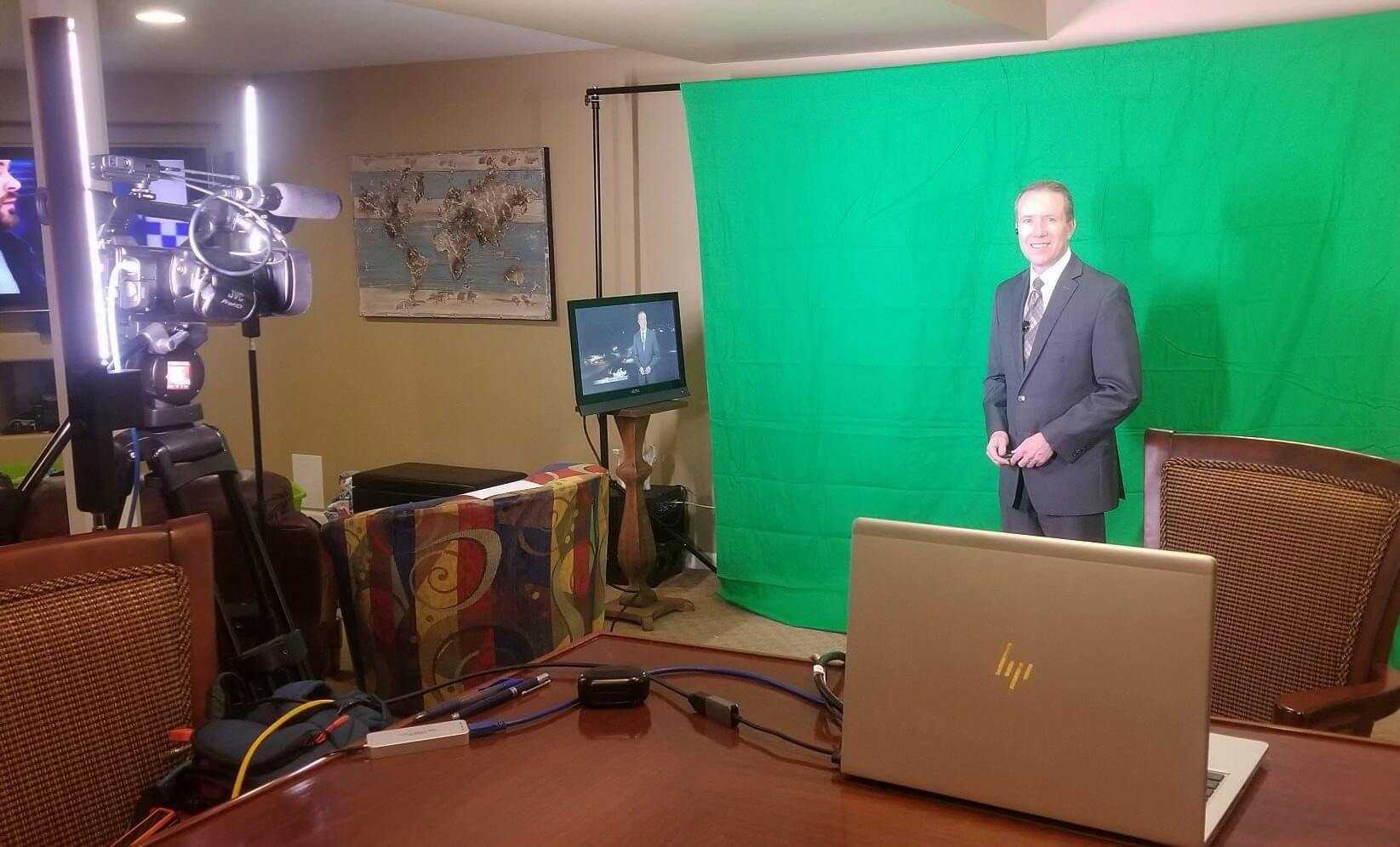 Image of Ron Demers in front of greenscreen while doing at-home weather.